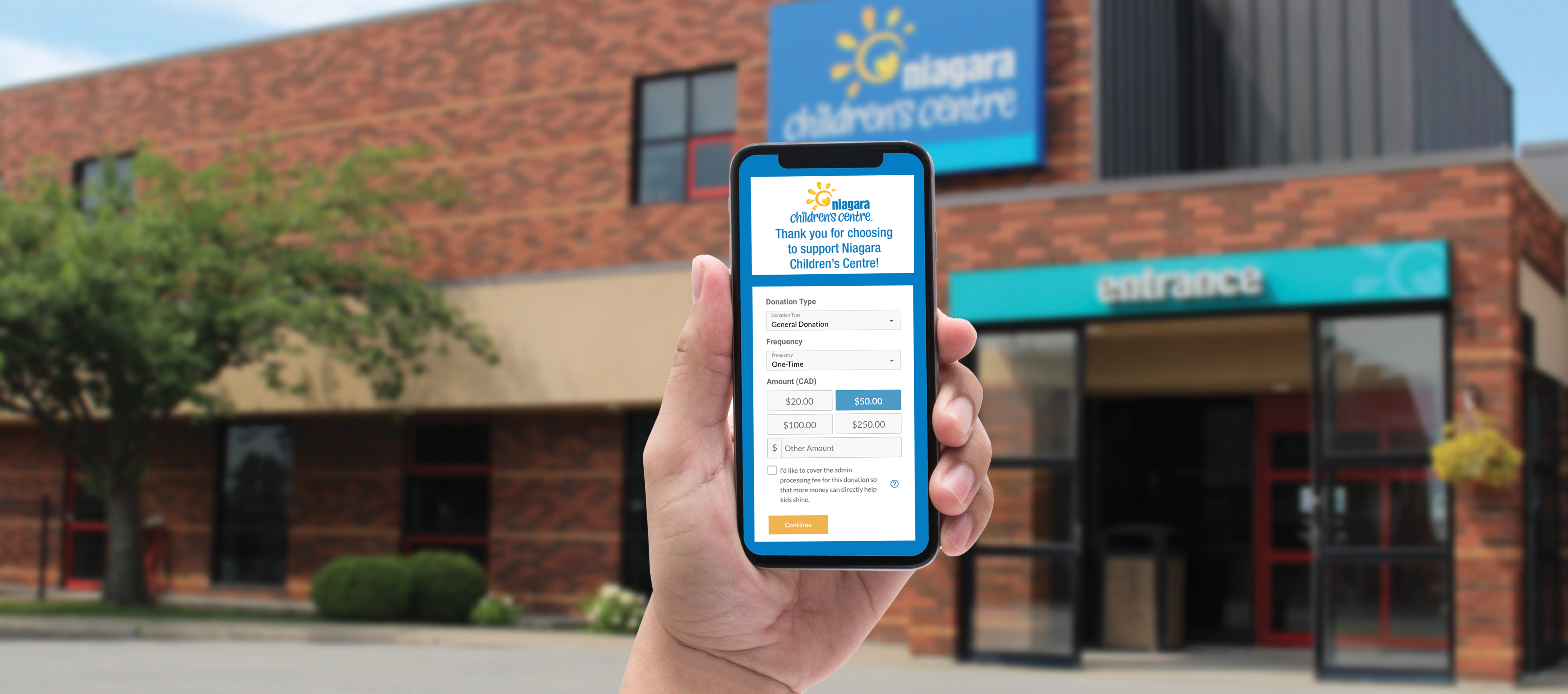 Hand holding smartphone showing Niagara Children’s Centre’s mobile donations webpage